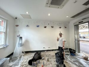  64f0633295df6 64f0633295df8dave Gnasher Nash With The Mural Underway.png